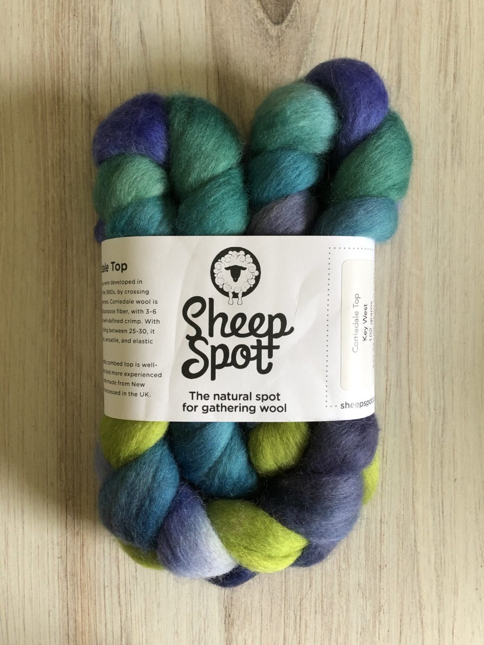 A braid of fiber in greens and blues