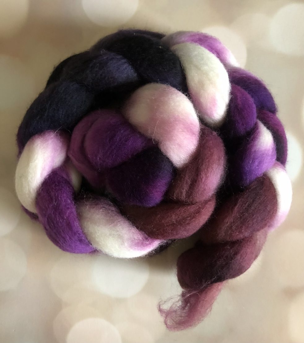 A braid of fiber in plums, burgundies, violet and white with hints of pink.