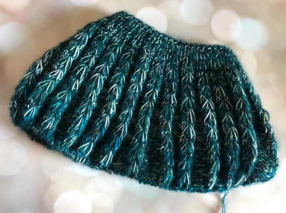A sweater yoke featuring suri alpaca held doubled with sock yarn, and columns of dip stitches against a background of reverse stockinette.